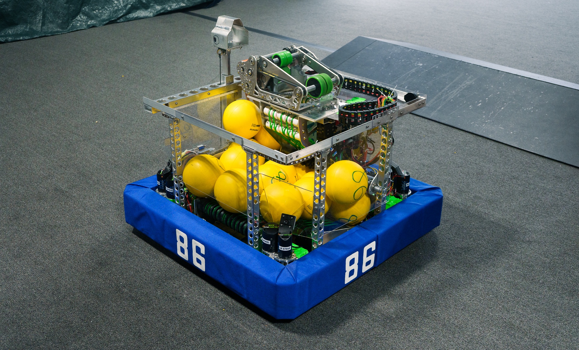 Team 86's robot on the practice field carrying a load of yellow game pieces